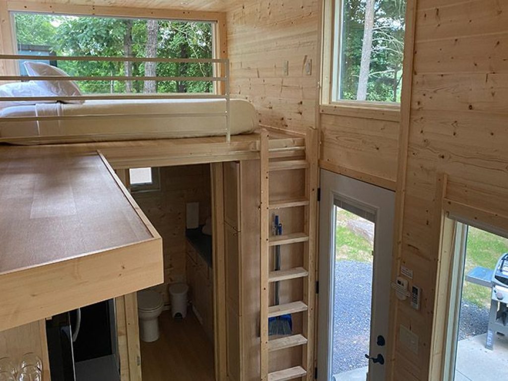 A ladder leading to a king loft bed