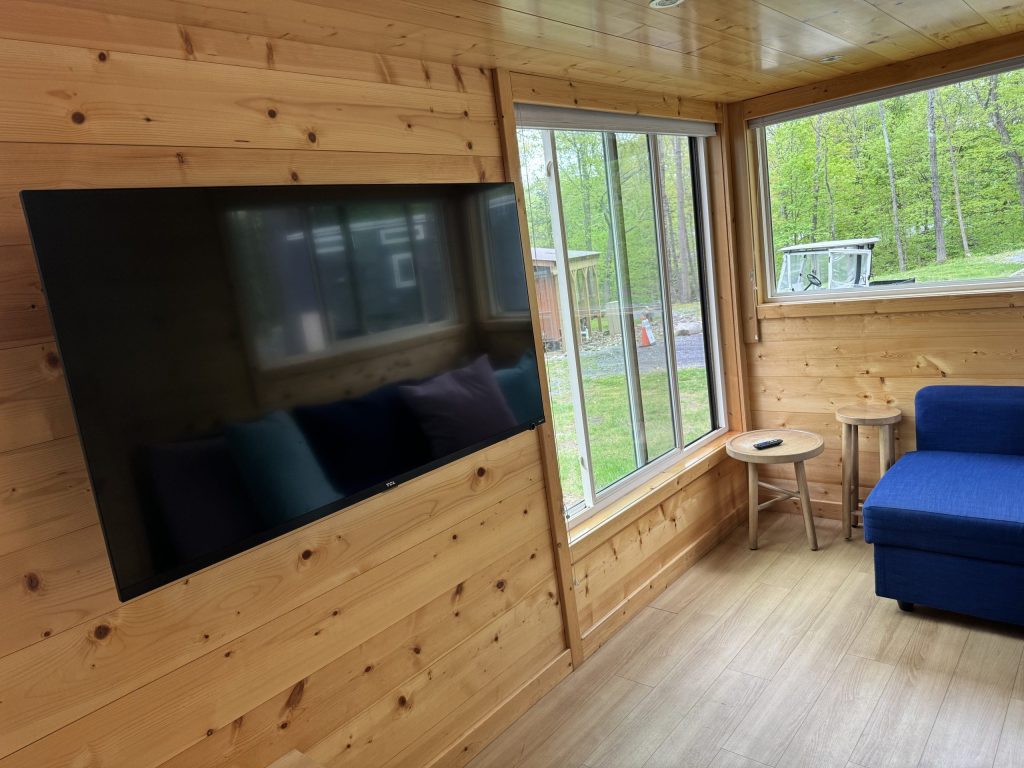 TV and large window overlooking the catskill creek