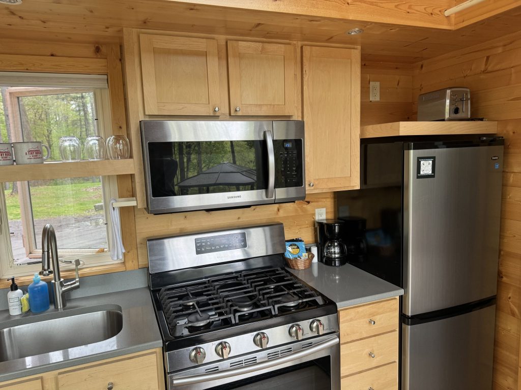 Full kitchen with 5 burner stove oven full refrigerator and sink