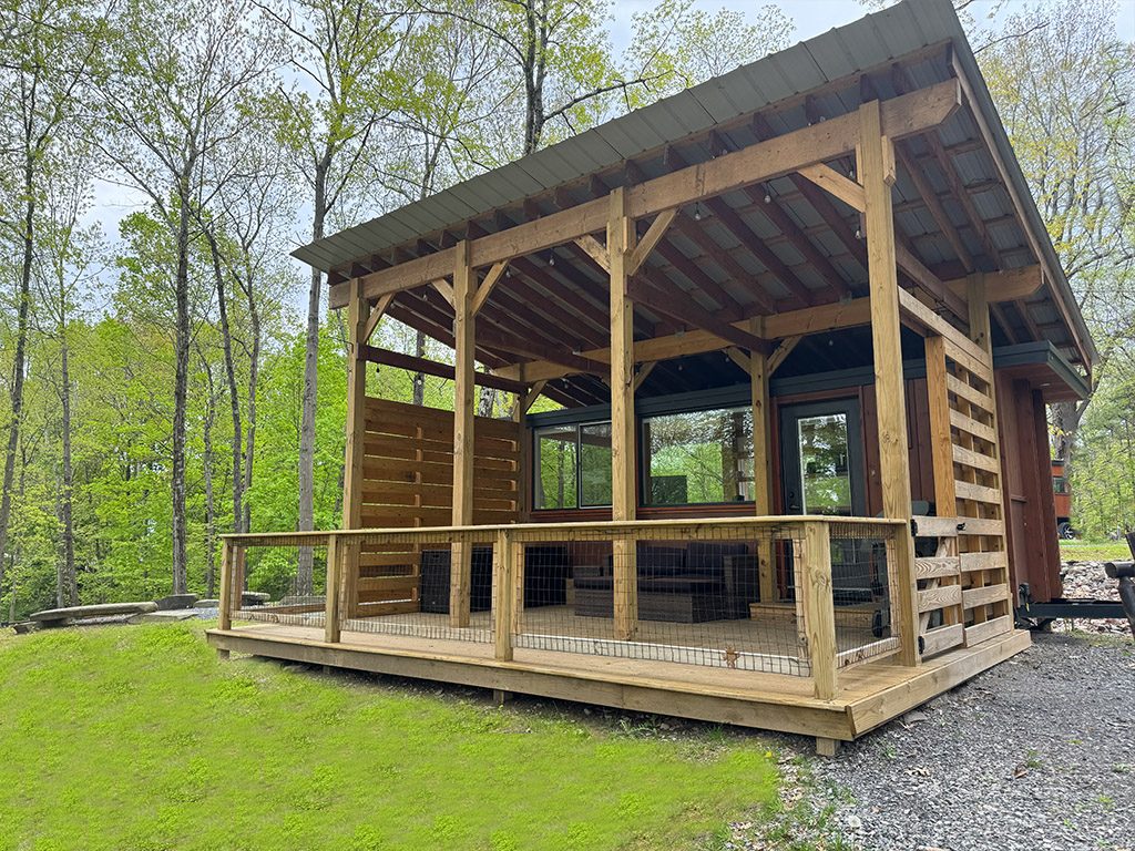The fully Covered TIny House with a fenced deck
