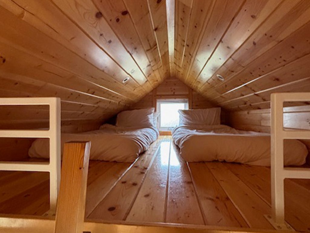 Twin beds up a loft at the Lodge